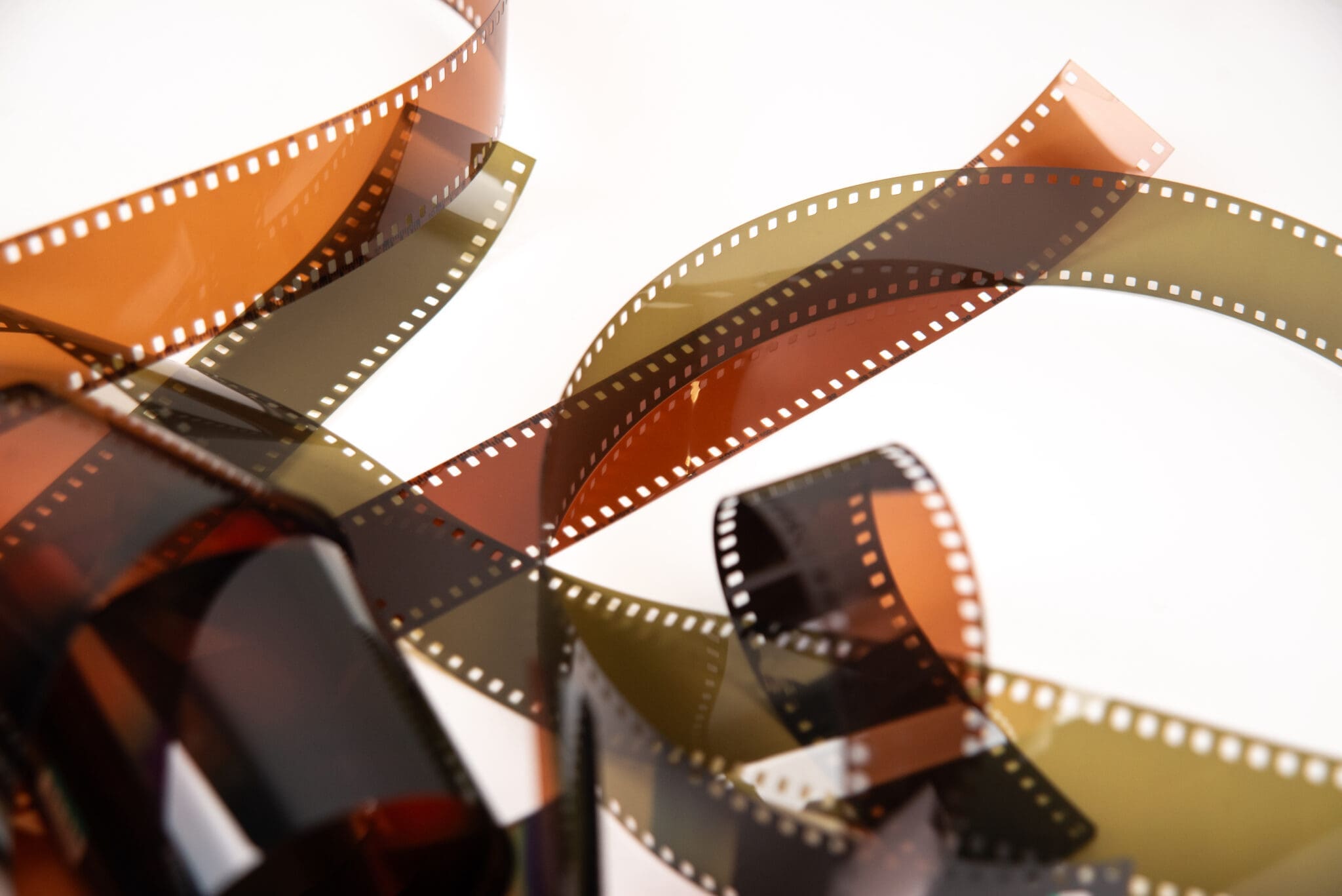 Developed color and black-and-white 35mm film negatives on a white background